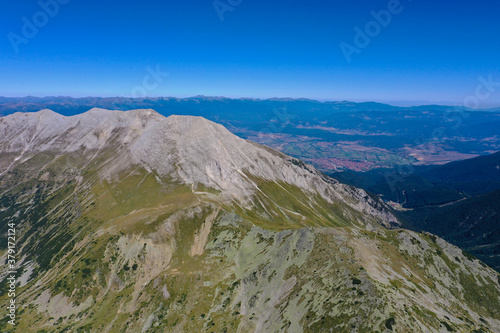 Amazing beautiful alpine valley and mountain peak. Wild nature, summer, blue sky. 