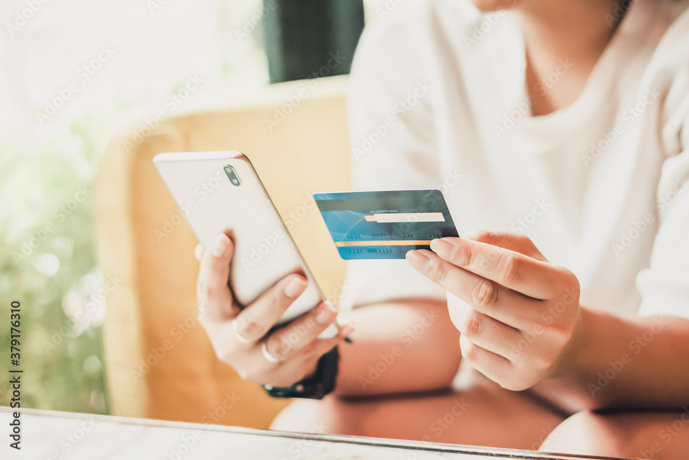 Woman hands holding credit card and Phone for with shopping online, Online payment concept.
