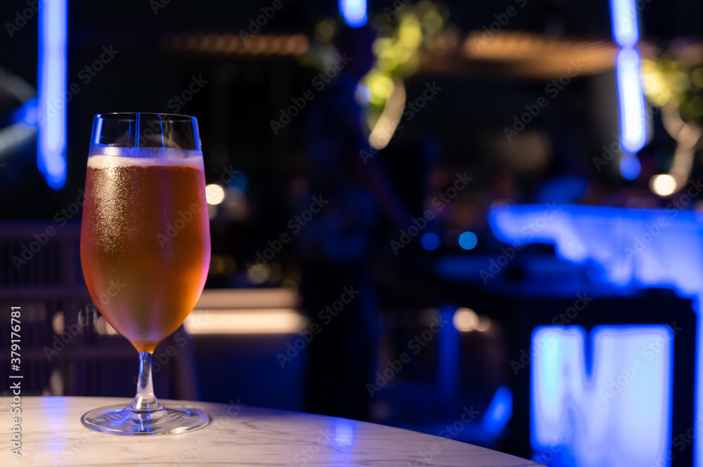 Food and drinks series: Glass of beer on marble top table in night club
