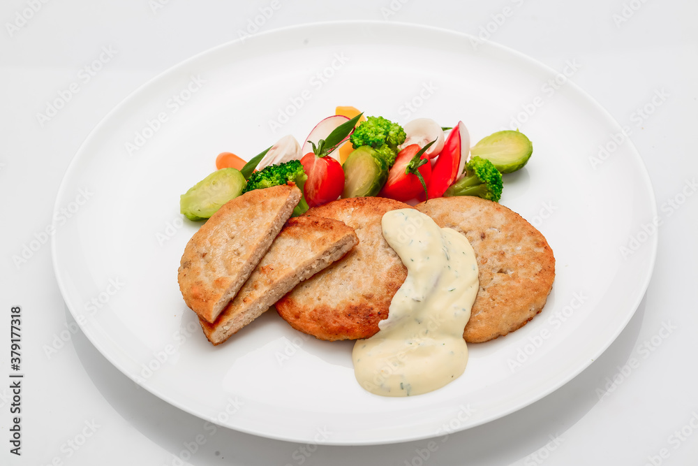 schnitzel, chicken cutlet with white sauce and vegetables schnitzel, chicken cutlet with white sauce and vegetables