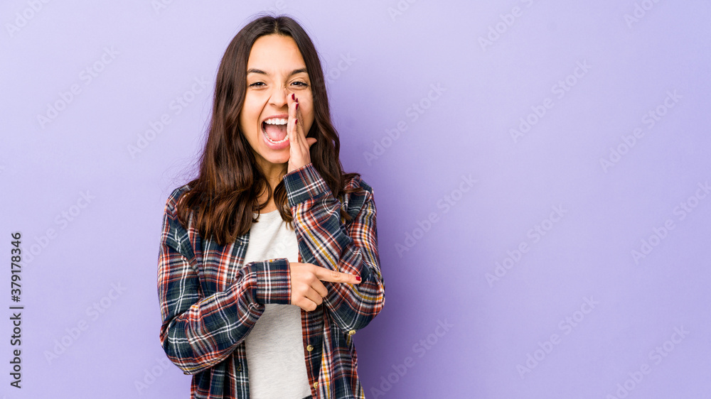 Young mixed race hispanic woman isolated saying a gossip, pointing to side reporting something. Young mixed race hispanic woman isolated saying a gossip, pointing to side reporting something.