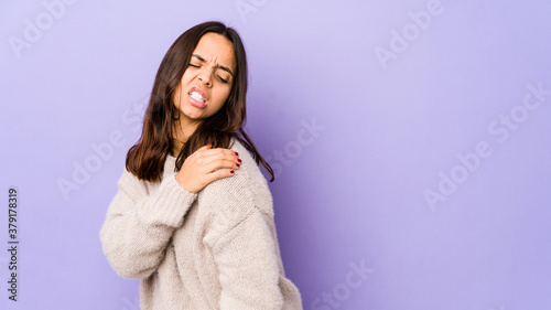Young mixed race hispanic woman isolated having a shoulder pain. © Asier
