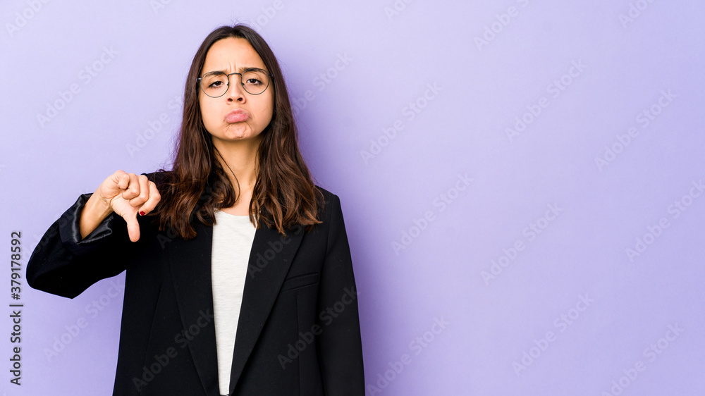 Young mixed race hispanic woman isolated showing a dislike gesture, thumbs down. Disagreement concept.