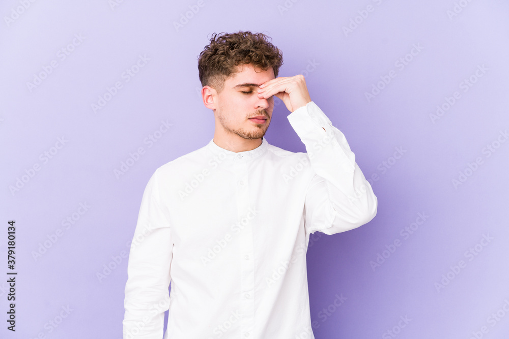 Young blond curly hair caucasian man isolated having a head ache, touching front of the face. Young blond curly hair caucasian man isolated having a head ache, touching front of the face.