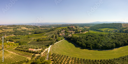 Aerial/Drone Panorama of Tuscany Landscape with vineyards and olive trees - With Montauto castle and San Gimignano - Italy photo