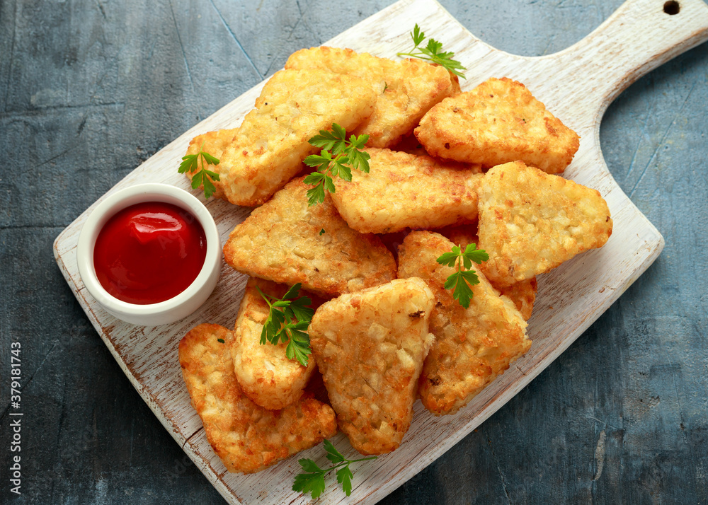 Hash brown potato with ketchup on white wooden board Hash brown potato with ketchup on white wooden board