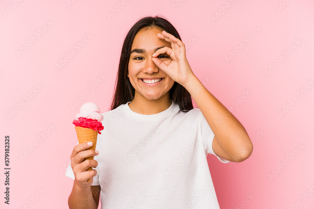 Young asian woman holding a ice cream isolated excited keeping ok gesture on eye. Young asian woman holding a ice cream isolated excited keeping ok gesture on eye.