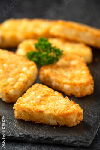 Canvastavla Hash brown potato patties on rustic stone board