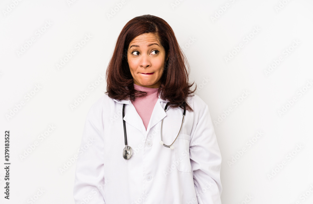 Middle age latin doctor woman isolated confused, feels doubtful and unsure. Middle age latin doctor woman isolated confused, feels doubtful and unsure.