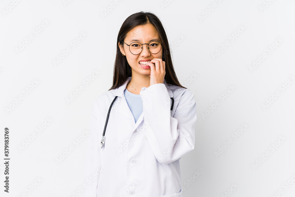 Young doctor chinese woman isolated biting fingernails, nervous and very anxious. Young doctor chinese woman isolated biting fingernails, nervous and very anxious.