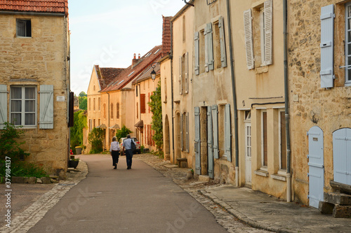 Little town in Burgundy  France.  Flavigny-sur-Ozerain is a commune in the French department of C  te-d Or  in Bourgogne-Franche-Comt  . Red roofs  stone  houses surrounded by trees.