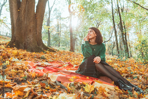 portrait of young smiling woman in autumn yellow park