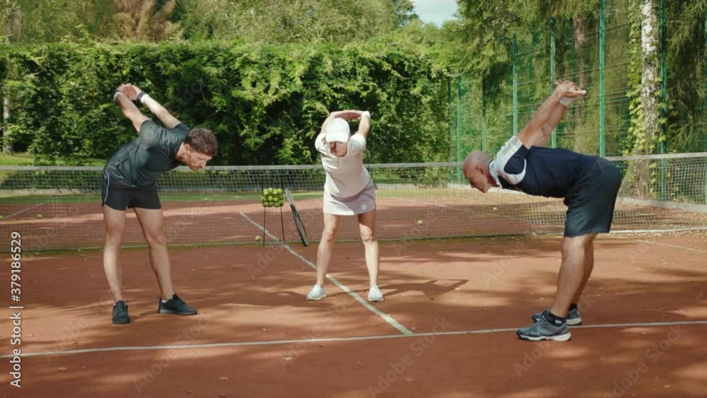 Smiling players warm up before a game of tennis with trainer success match training course exercise fitness man woman athlete fun sport court summer close up slow motion Smiling players warm up before a game of tennis with trainer success match training course exercise fitness man woman athlete fun sport court summer close up slow motion