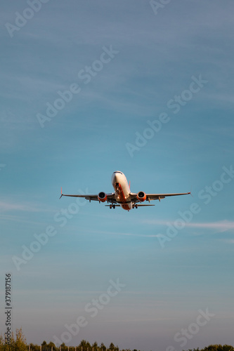 view of airplane landing on sunset
