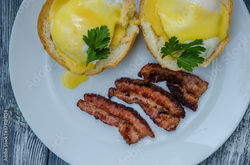 Homemade Benedict Eggs on the plate with souce photo