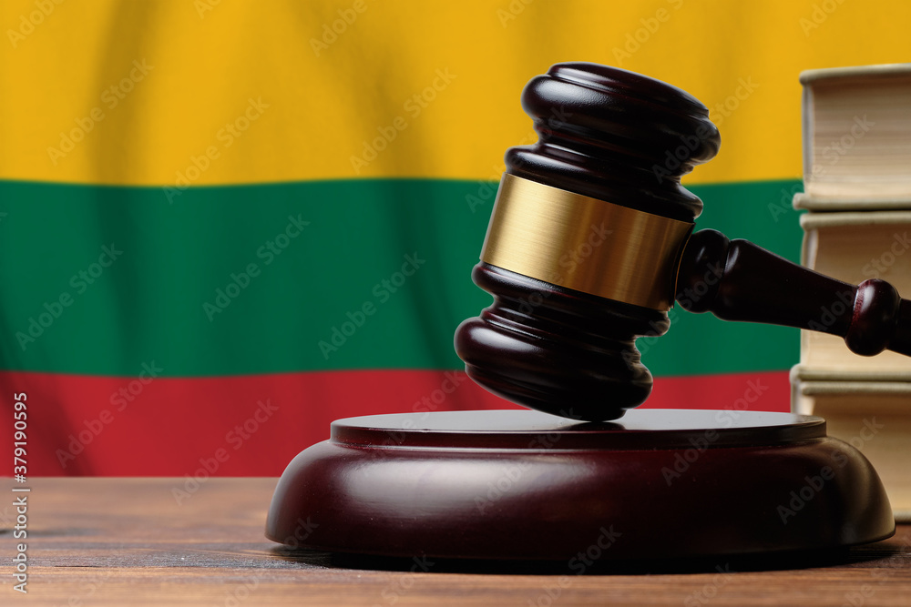 Justice and court concept in Republic of Lithuania. Judge hammer on a flag background
