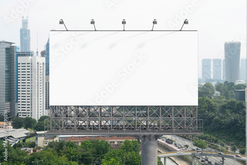 Obraz na płótnie Blank white road billboard with KL cityscape background at day time