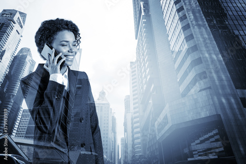 Successful smiling black African American business woman in suit pensively talking phone, Singapore cityscape. The concept of consultants as problem solvers. Investment fund. Double exposure.