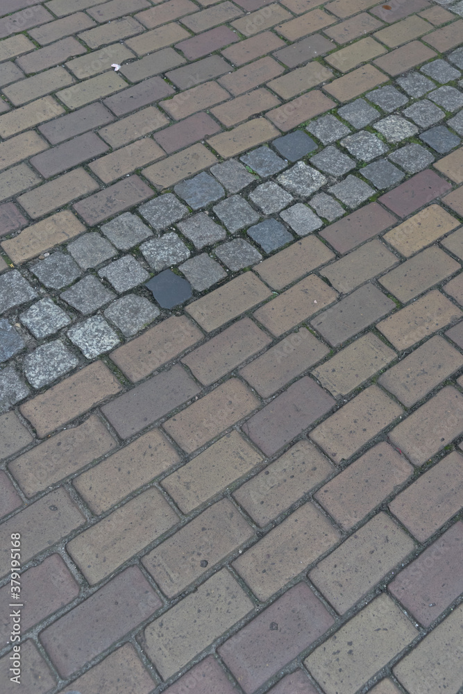Background of old red brick and cobblestone pavement