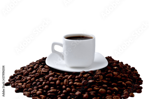 white cup of coffee on a white saucer stands on a hill of coffee beans on a white background   angle view from above