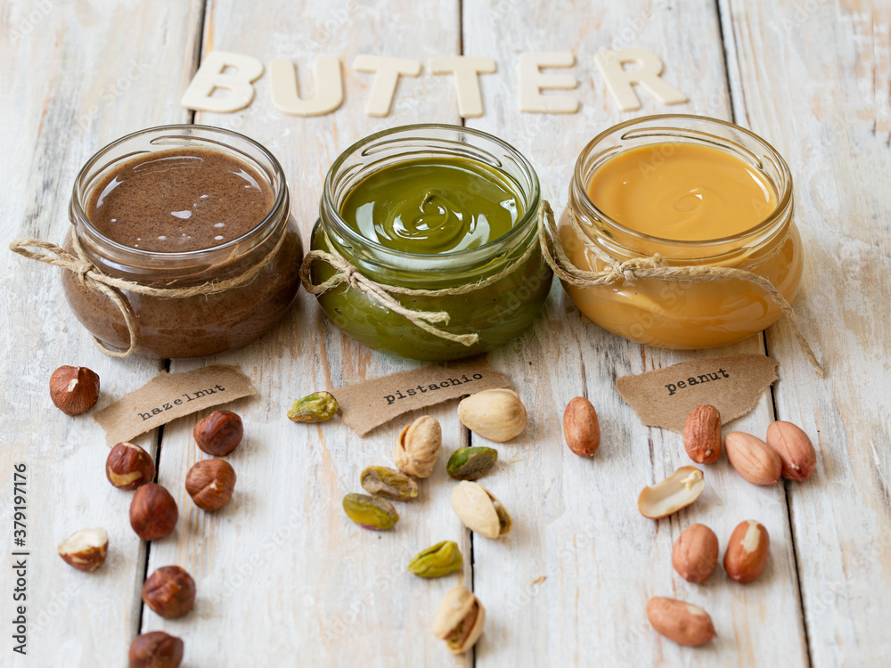 Nuts butter in jars with ingredients. Homemade raw organic peanut, hazelnut, pistachio, nuts paste butter. Nuts butter in jars with ingredients. Homemade raw organic peanut, hazelnut, pistachio, nuts paste butter.