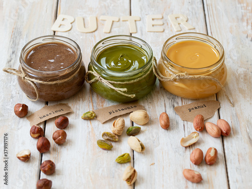 Canvas Print Nuts butter in jars with ingredients