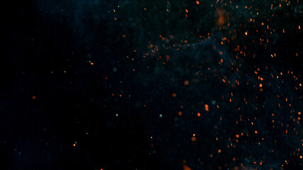 Flying sparks isolated on black background, close-up