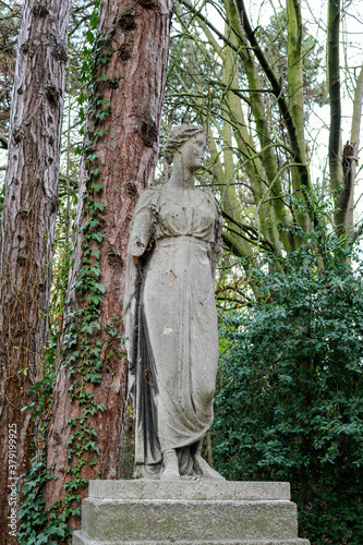 A dilapidated statue of a woman in an autumn park. Dublin. Ireland.