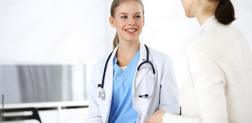 Woman - doctor consults her female patient while using clipboard and medication history record. Medicine concept Woman - doctor consults her female patient while using clipboard and medication history record. Medicine concept