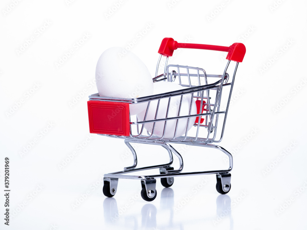 small food basket on wheels with chicken eggs on a white background small food basket on wheels with chicken eggs on a white background