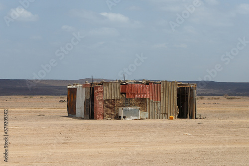 a lonely house in the middle of the desert made of colored metal sheets photo