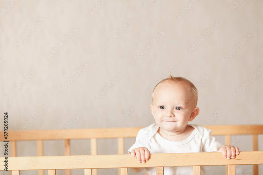 baby stands in the crib in the bedroom and smile close up baby stands in the crib in the bedroom and smile close up