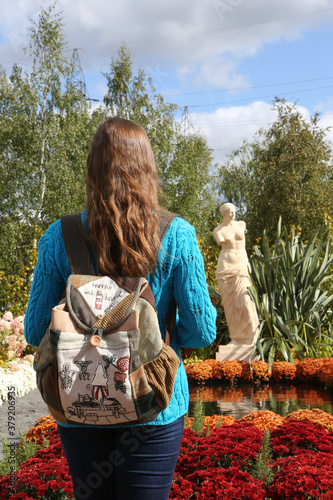 Park Tsaritsyno in Moscow city, Russia. Tsaritsino Festival of Historical Gardens 2020. Russian tourist woman with backpack. Moscow urban garden, landscape. Flowers decor, floral decoration. Landmark photo