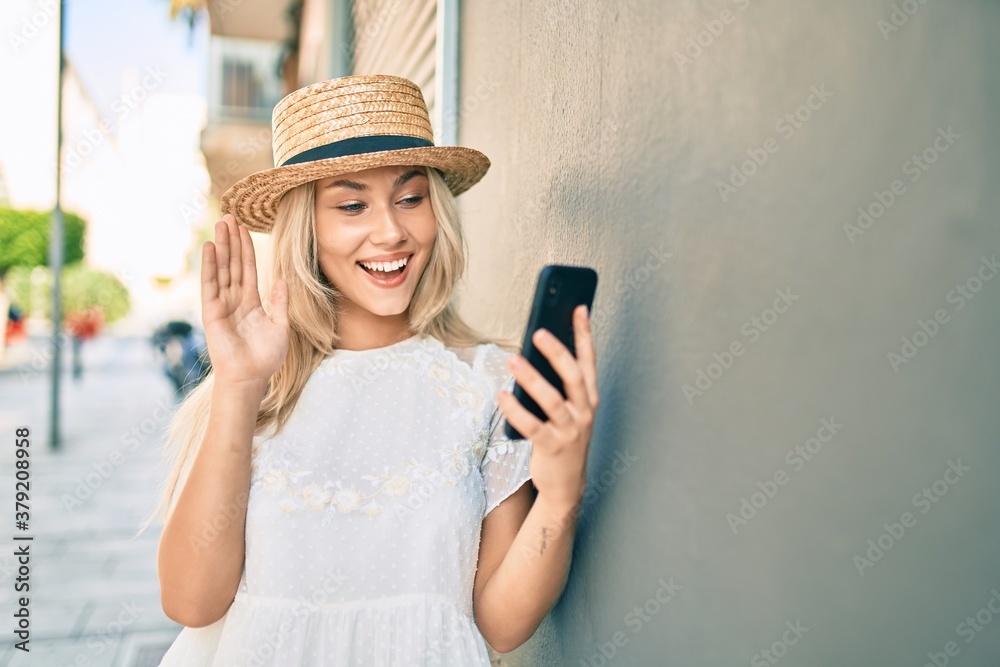 Young caucasian tourist girl doing video call using smartphone at city.