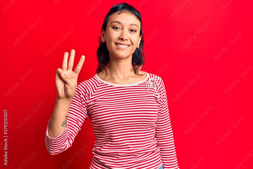 Young woman wearing casual clothes showing and pointing up with fingers number three while smiling confident and happy. Young woman wearing casual clothes showing and pointing up with fingers number three while smiling confident and happy.