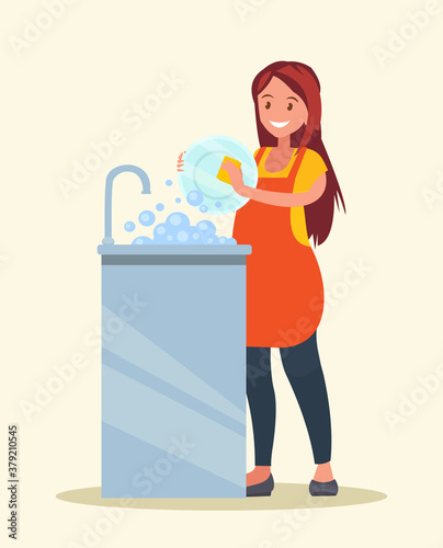 Housewife. The woman wearing in an apron is washing dishes.