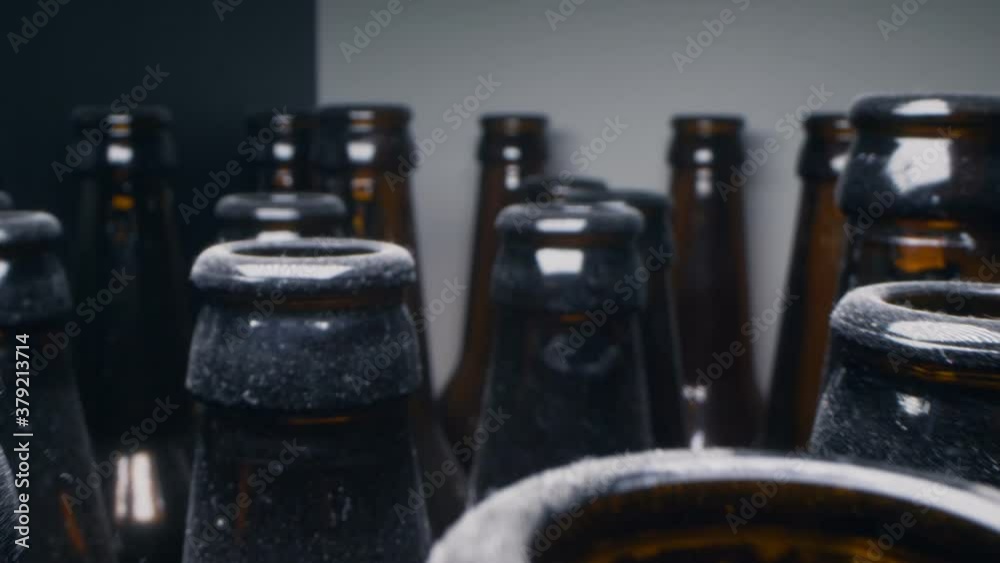 super close up, rows of empty dusty brown glass bottles super close up, rows of empty dusty brown glass bottles