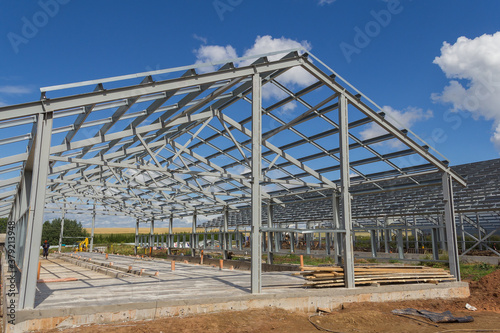 Steel frame of a building under construction. The construction of the building is made of steel beams. Construction of prefabricated structures
