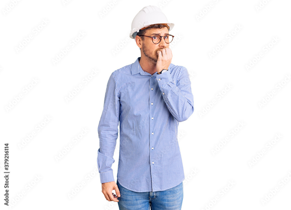 Handsome young man with bear wearing architect hardhat looking stressed and nervous with hands on mouth biting nails. anxiety problem. Handsome young man with bear wearing architect hardhat looking stressed and nervous with hands on mouth biting nails. anxiety problem.