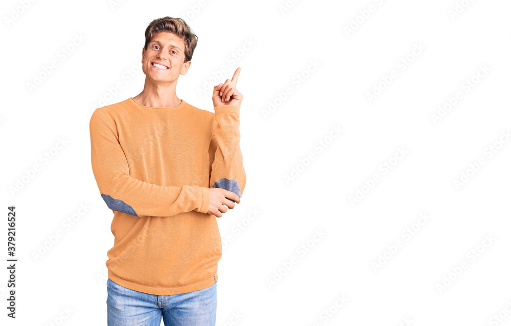 Young handsome man wearing casual clothes with a big smile on face, pointing with hand and finger to the side looking at the camera. Young handsome man wearing casual clothes with a big smile on face, pointing with hand and finger to the side looking at the camera.