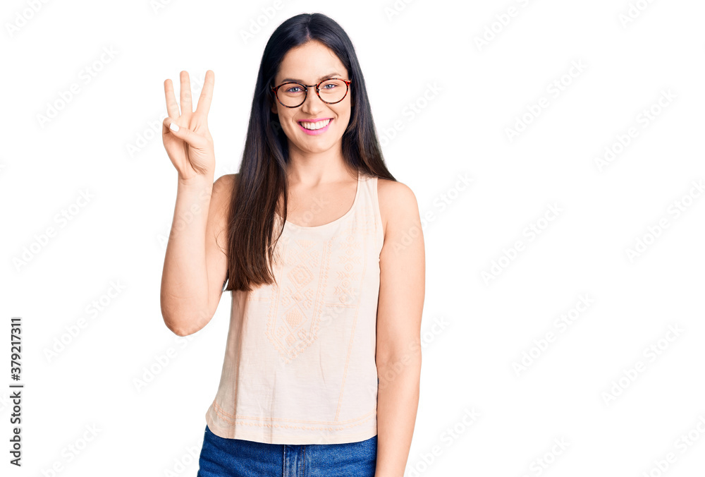 Young beautiful caucasian woman wearing casual clothes and glasses showing and pointing up with fingers number three while smiling confident and happy. Young beautiful caucasian woman wearing casual clothes and glasses showing and pointing up with fingers number three while smiling confident and happy.