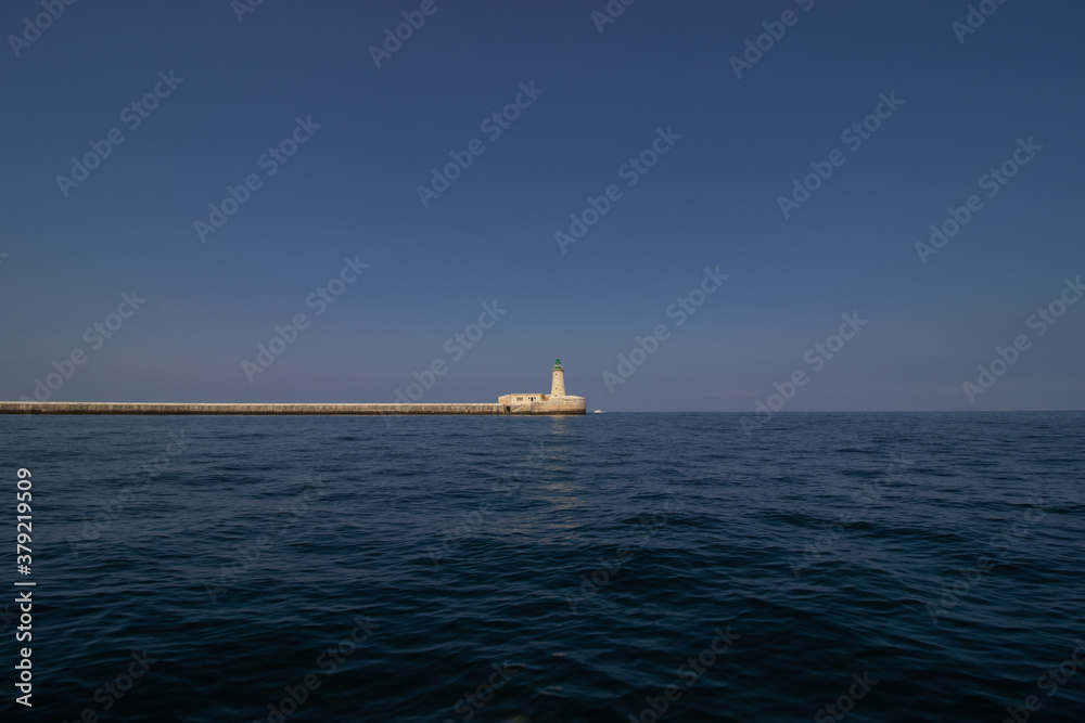 lighthouse by valetta city. ligthouse at sea. Grand Harbor at the City of Valletta, Malta. boatt background