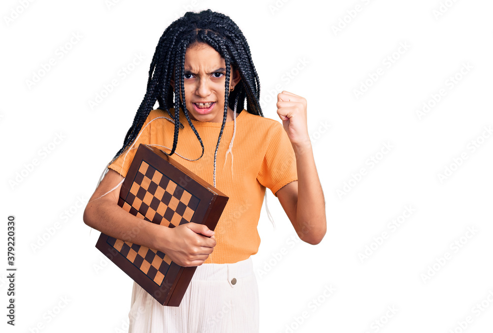 Cute african american girl holding chess annoyed and frustrated shouting with anger, yelling crazy with anger and hand raised