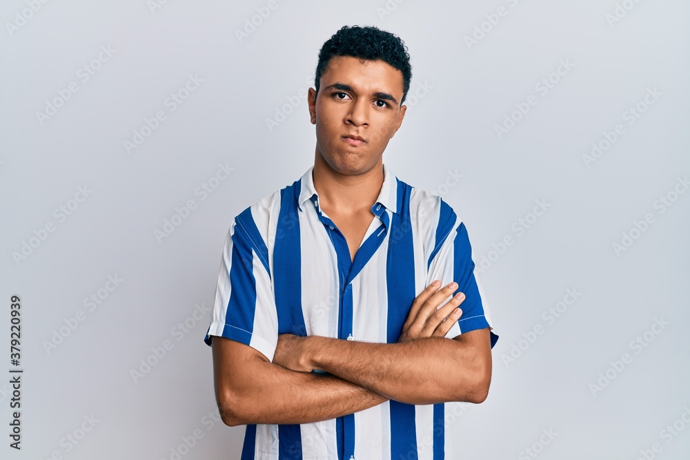 Young arab man wearing casual clothes skeptic and nervous, disapproving expression on face with crossed arms. negative person. Young arab man wearing casual clothes skeptic and nervous, disapproving expression on face with crossed arms. negative person.