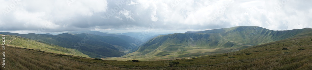 panorama of landscape with clouds over the mountains