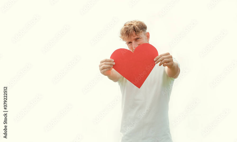 young happy casual man holding a big red heart for valentine's day on white background
young happy casual man holding a big red heart for valentine's day on white background
