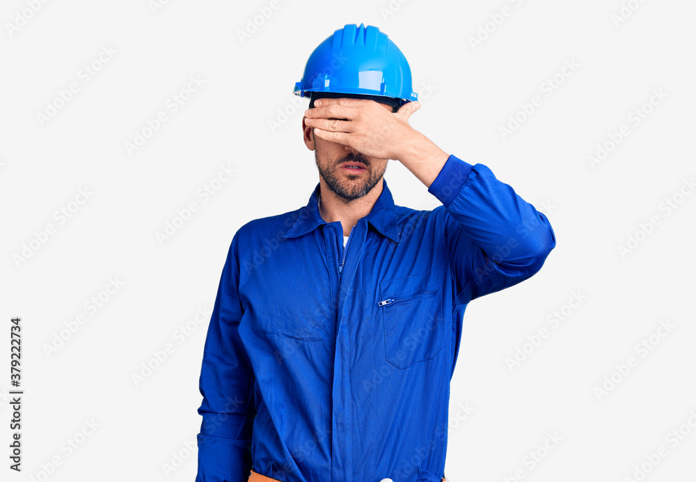 Young handsome man wearing worker uniform and hardhat clueless and confused with open arms, no idea concept. Young handsome man wearing worker uniform and hardhat clueless and confused with open arms, no idea concept.
