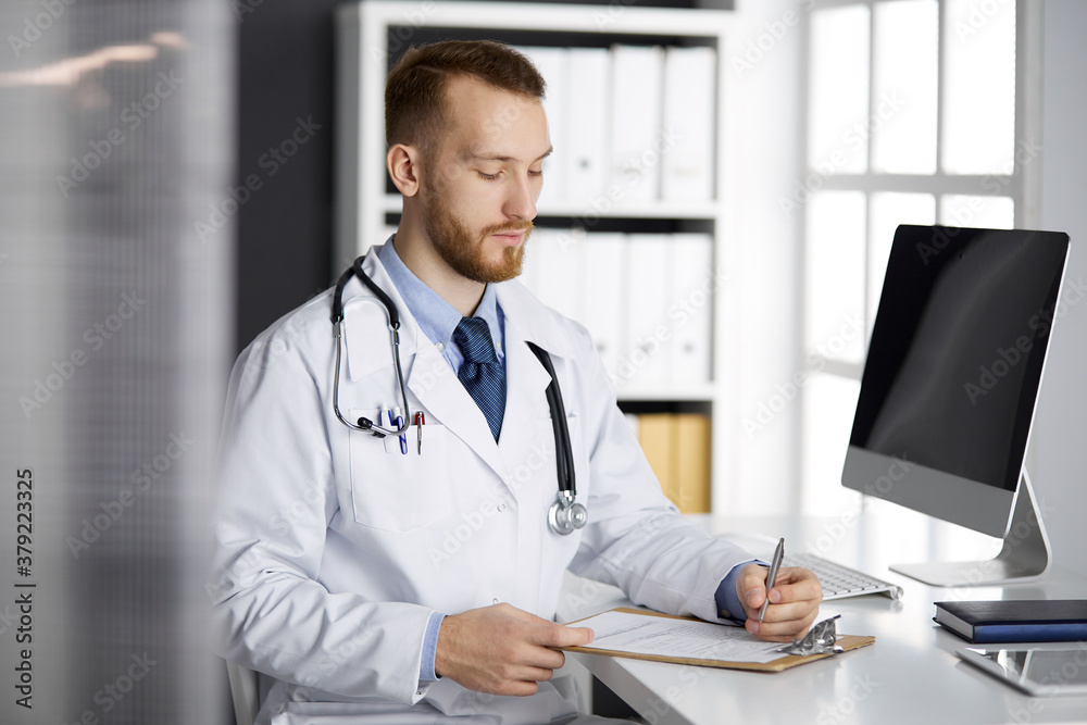 Friendly red-bearded doctor and patient woman discussing current health examination while sitting in sunny clinic. Medicine concept Friendly red-bearded doctor and patient woman discussing current health examination while sitting in sunny clinic. Medicine concept