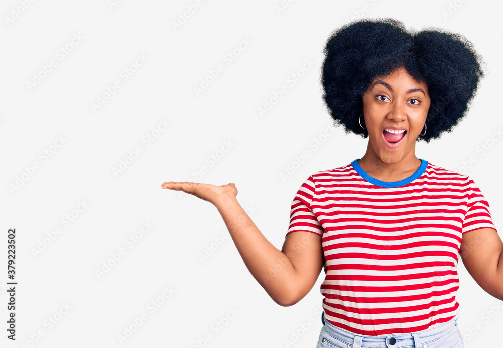 Young african american girl wearing casual clothes celebrating victory with happy smile and winner expression with raised hands Young african american girl wearing casual clothes celebrating victory with happy smile and winner expression with raised hands