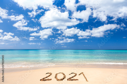 2021 written on sandy beach